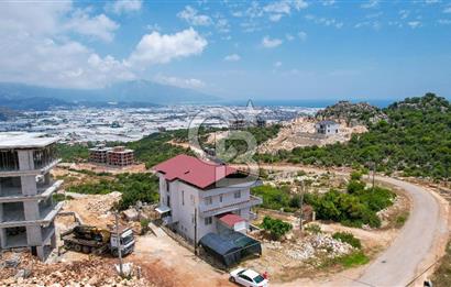 ANTALYA DEMRE BOZDAĞ'DA ÖNÜ KAPANMAZ DENİZ MANZARALI ARSA VE BİNASI