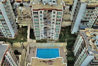 Bayraklı Yamanlar’da Deniz Manzaralı, Güvenlikli Sitede 3+1 Ferah Daire