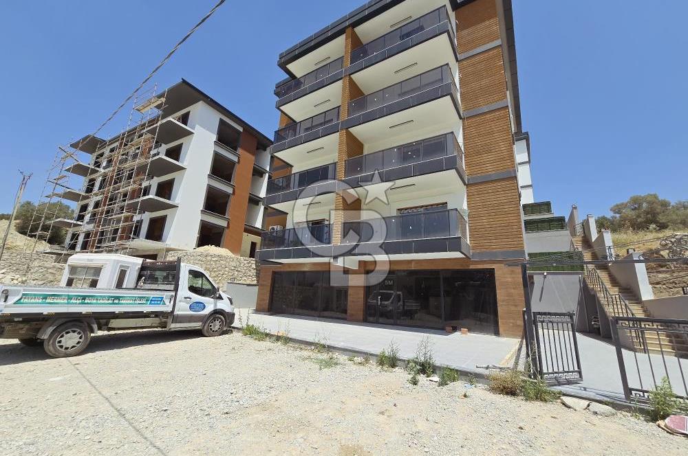 Kuşadası’nın Gelişen Bölgesi Kirazlı Yolu Üzerinde, Cadde Cepheli, Yüksek Tabela Değerine Sahip Sıfır Dükkan Fırsatı!