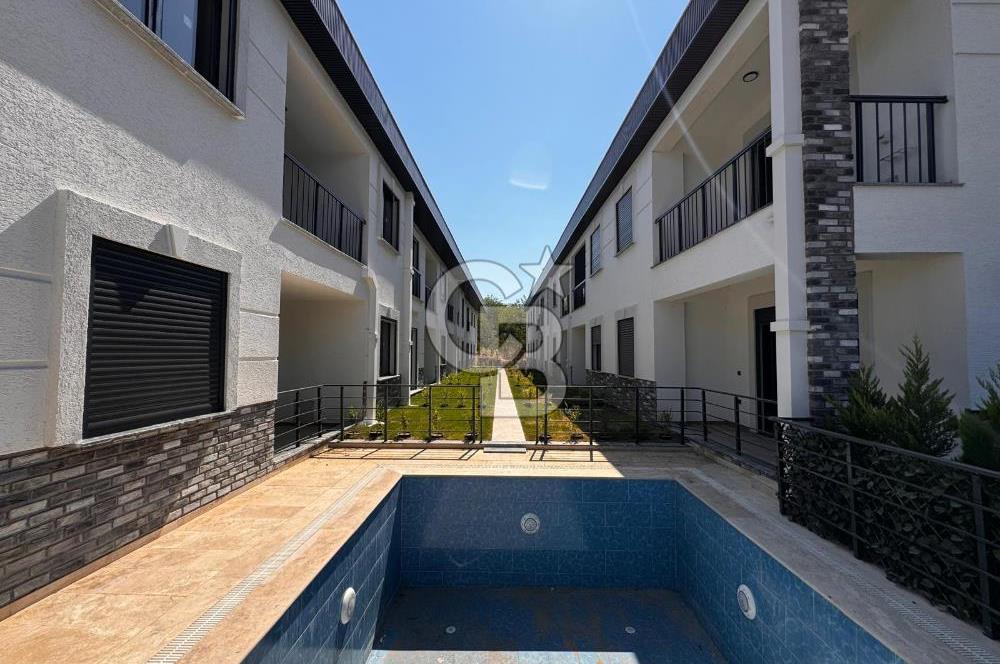 GÜRE ÇAMLIBELDE BAHÇE KULLANIMLI HAVUZLU SATILIK 1+1 DAİRE