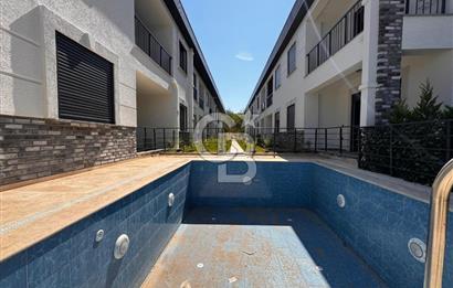 GÜRE ÇAMLIBELDE BAHÇE KULLANIMLI HAVUZLU SATILIK 1+1 DAİRE