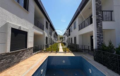 GÜRE ÇAMLIBELDE BAHÇE KULLANIMLI HAVUZLU SATILIK 1+1 DAİRE