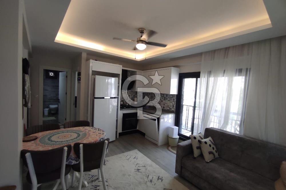 DİKİLİ ÇANDARLI MERKEZDE 1+1 EŞYALI BAHÇELİ SATILIK DAİRE