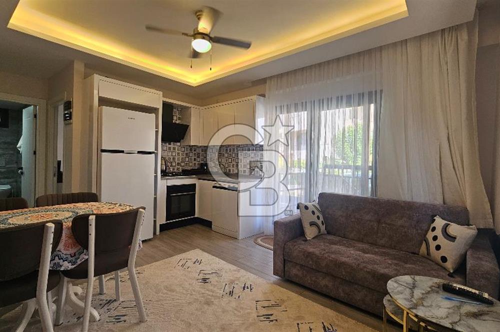 DİKİLİ ÇANDARLI MERKEZDE 1+1 EŞYALI BAHÇELİ SATILIK DAİRE
