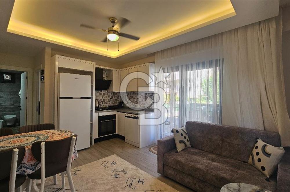 DİKİLİ ÇANDARLI MERKEZDE 1+1 EŞYALI BAHÇELİ SATILIK DAİRE