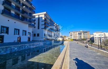 Kuşadası İkiçeşmelik te havuzlu sitede satılık 2+1 daire