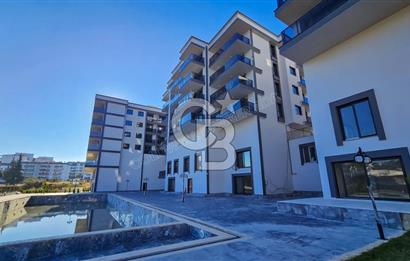 Kuşadası İkiçeşmelik te havuzlu sitede satılık 2+1 daire