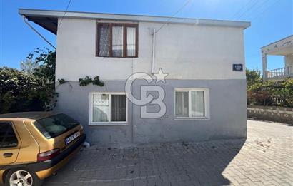 URLA GÜLBAHÇE'DE İÇERİSİNDE KAYITLI BİNA OLAN İMARLI ARSA
